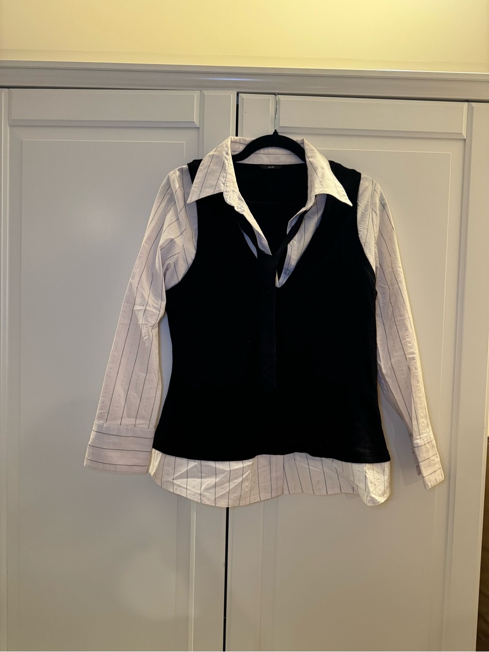 EVIE Black vest over White Collar pinstripe and tie